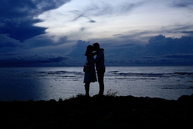 A loving couple overlooking beautiful nature, and enjoying the beautiful nature of their relationship. 