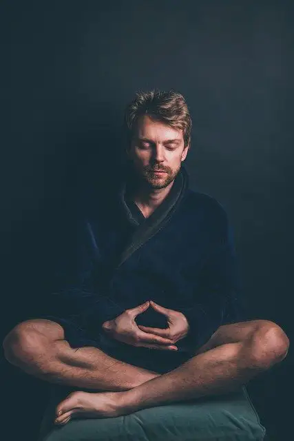 Man practicing meditation and mindfulness in the pursuit of peace and happiness.