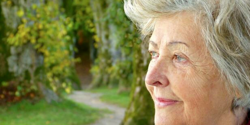 Older woman looking at nature, mustering inspiration to create affirmations for confidence.