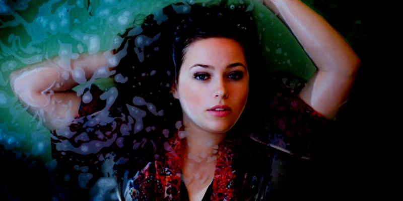 Woman floating in a state of deep relaxation, gaining benefits from sensory deprivation float therapy.