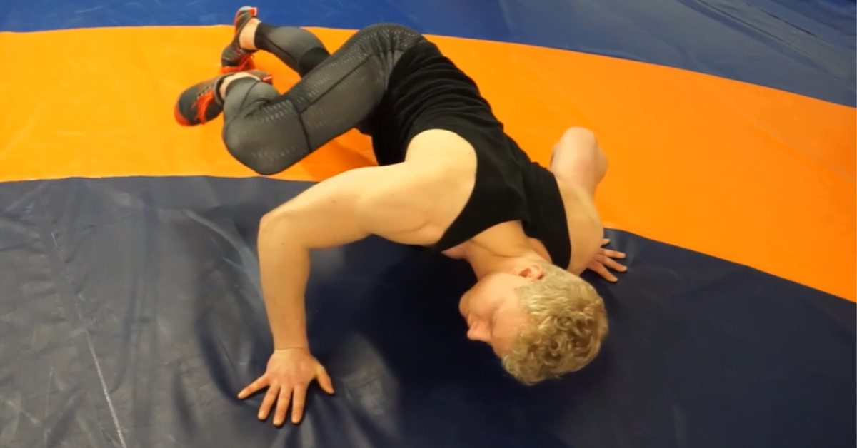 Eero Westerberg demonstrates a spiderman push-up, and helps contort the body. This exercise creates a back and forth movement of limbs and torso and challenges balance.